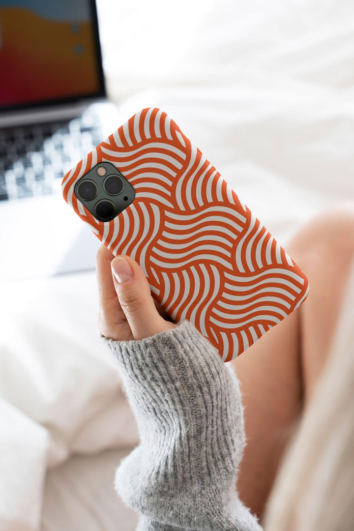 a woman holding a cell phone case in her hand