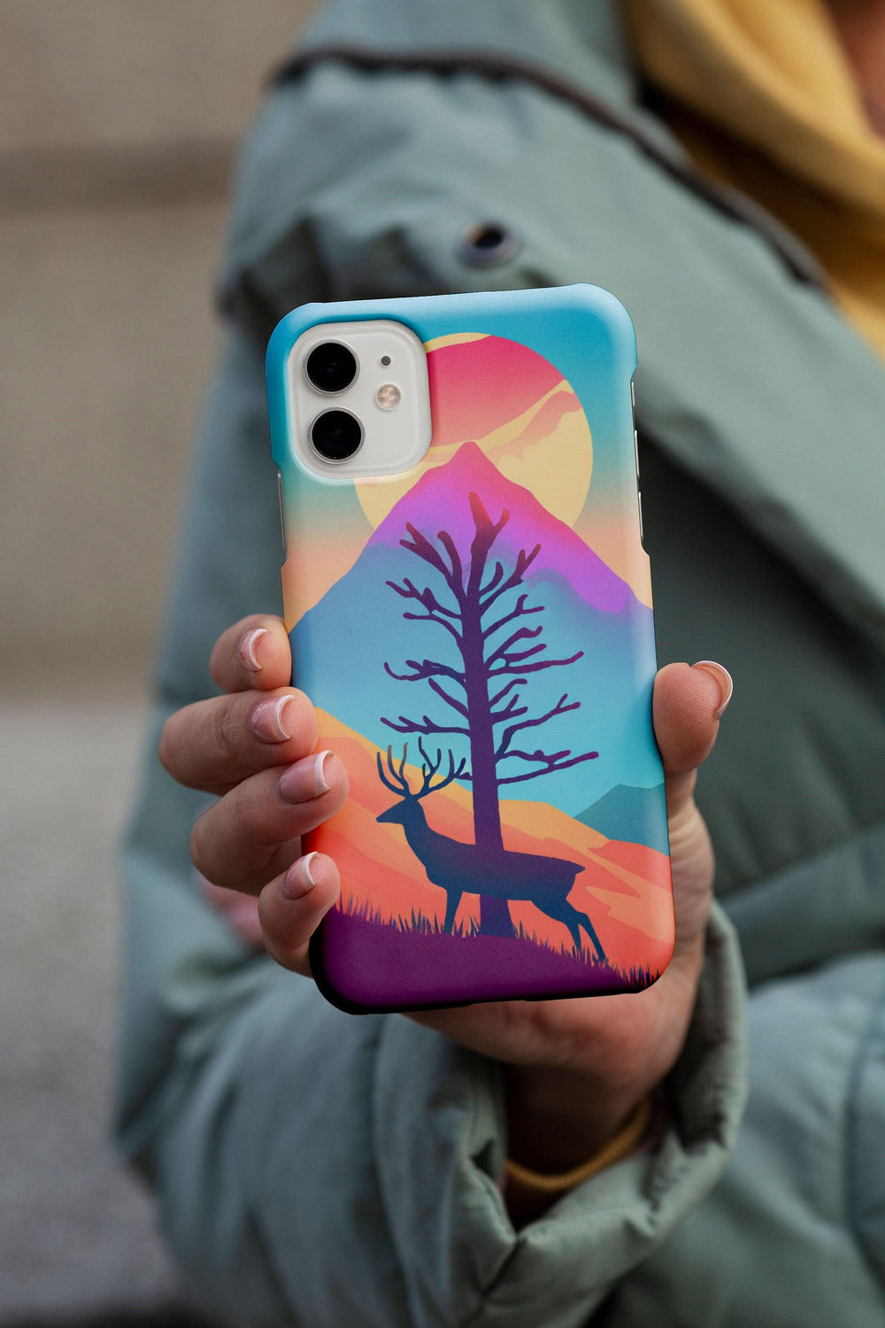 a person holding a phone case with a painting on it